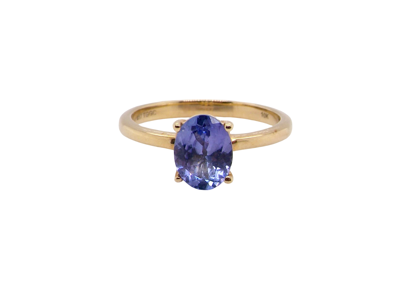 Gold ring with a tanzanite gemstone on a white background