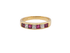 A beautiful 18-carat gold half-hoop eternity ring set with alternating rubies and diamonds. 