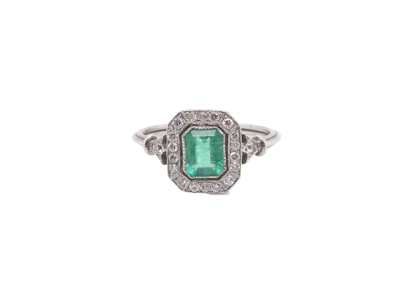 A beautiful Art Deco cluster ring centred with a vibrant step-cut emerald