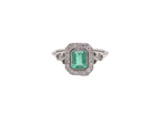 A beautiful Art Deco cluster ring centred with a vibrant step-cut emerald