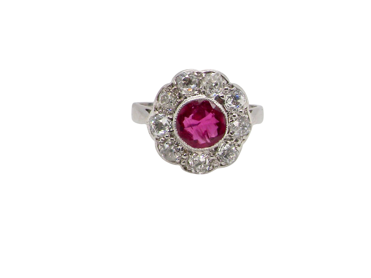 Ring with a pink gemstone and diamond-studded halo on a white background