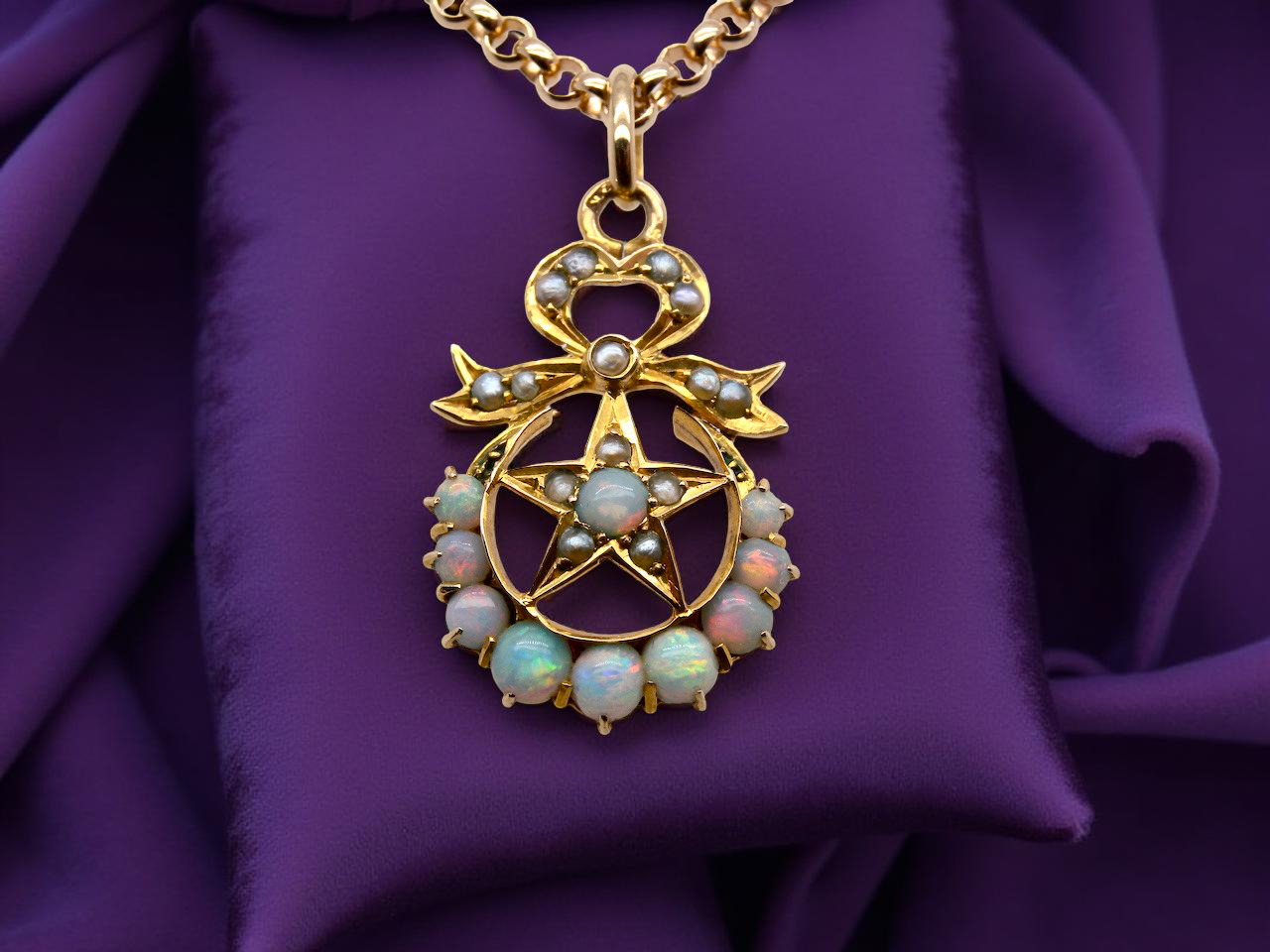 An antique Victorian pendant featuring opals and pearl