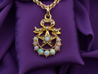 An antique Victorian pendant featuring opals and pearl