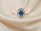 A ring featuring an oval-cut mid to dark blue sapphire measuring 7 × 5 mm (approximately ¾ carat).