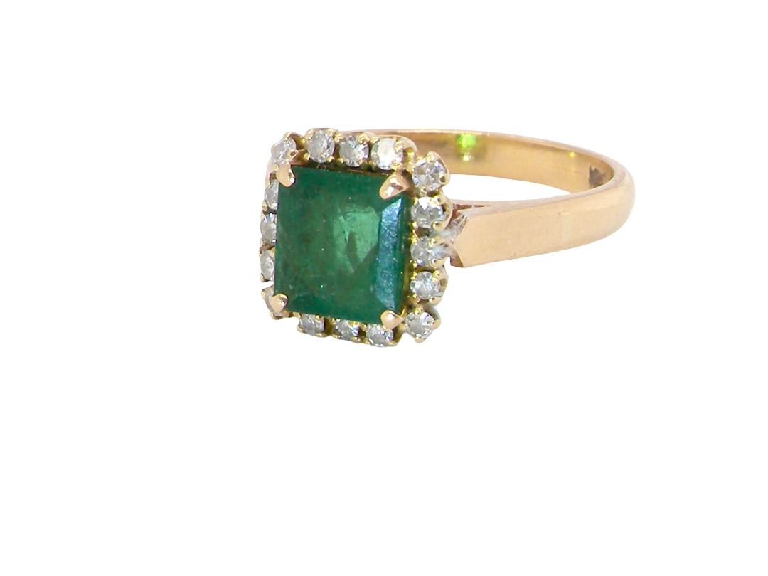A beautiful cluster ring set with a large square-cut emerald measuring approximately 7 x 7mm, displaying a deep grass-green colour 