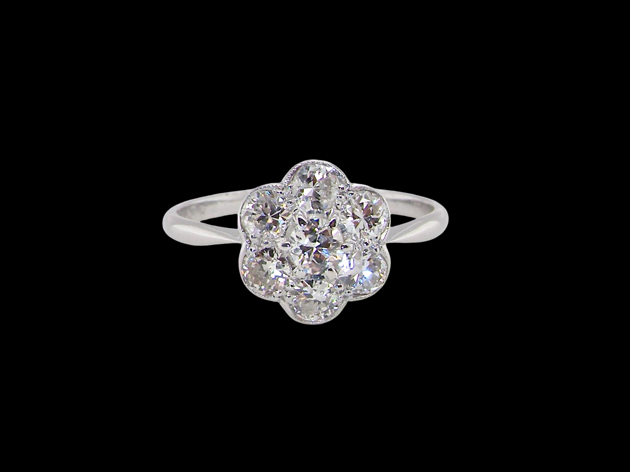 Diamond ring with floral design on a black background
