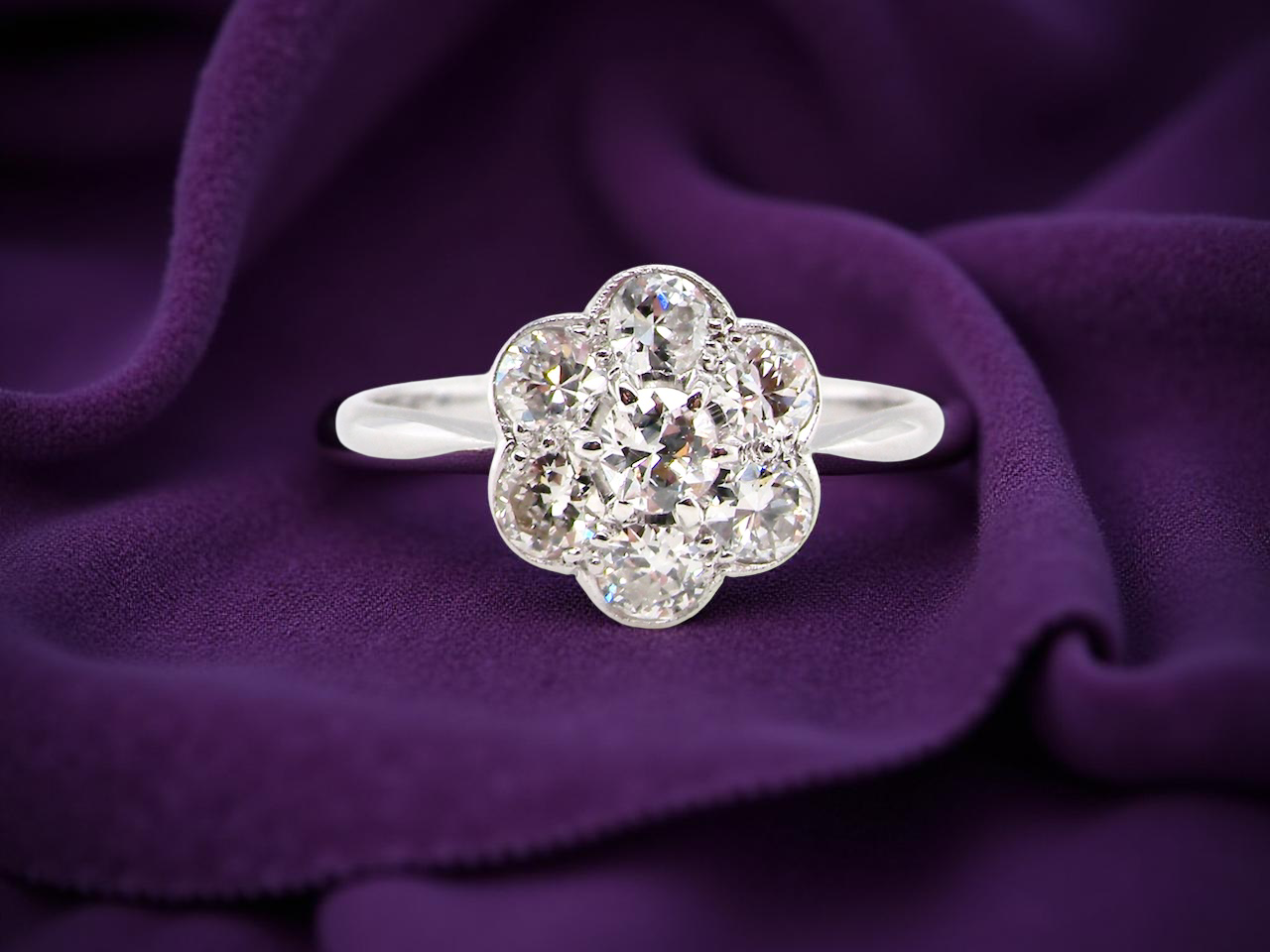 Diamond ring on a purple fabric background