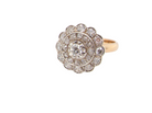 A beautiful vintage diamond cluster ring.&nbsp; Know as a target cluster, the diamonds are old brilliant cut. Centre diamond (0.20 carats) .&nbsp;