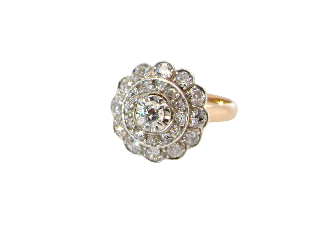 A beautiful vintage diamond cluster ring.&nbsp; Know as a target cluster, the diamonds are old brilliant cut. Centre diamond 3.8mm  .&nbsp;