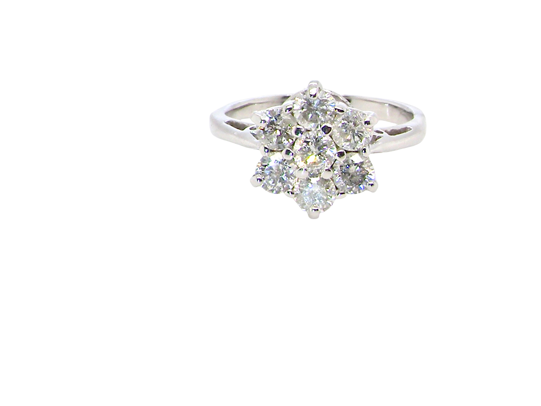 A beautiful vintage diamond cluster ring, elegantly set with seven brilliant-cut white diamonds in a timeless floral cluster design.