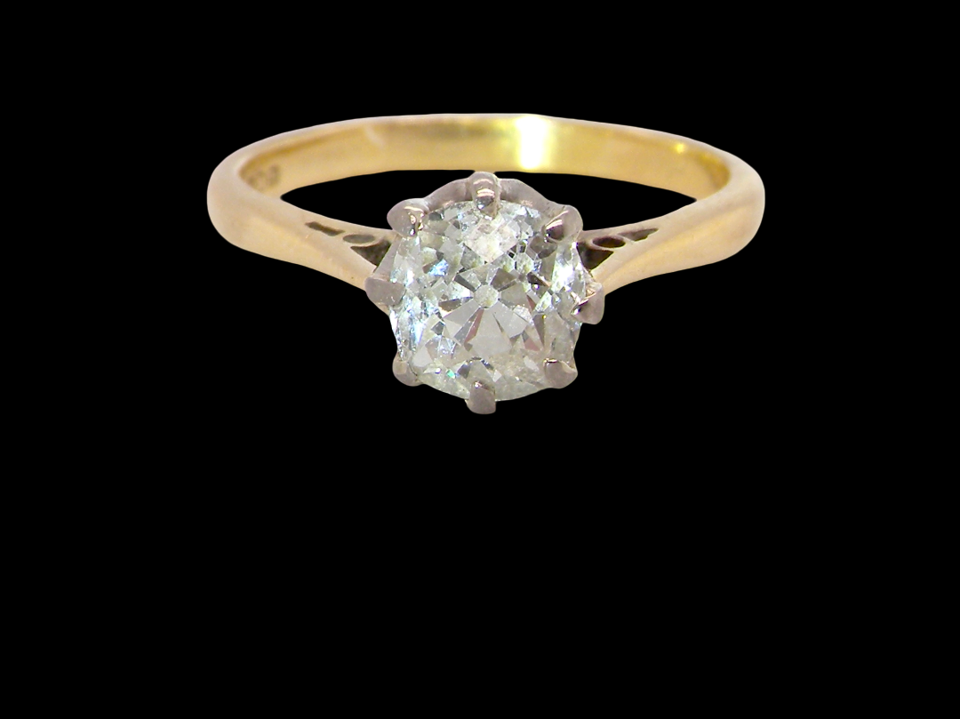 A beautiful vintage diamond solitaire ring featuring an old brilliant cut white diamond measuring approximately 6mm, estimated at 0.75 carats. The diamond displays attractive sparkle with an assessed colour 