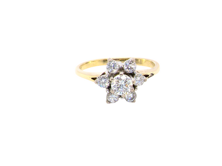 A beautifully crafted vintage diamond cluster ring, dating to the 1960s, featuring a classic floral-inspired design that remains timeless and elegant.