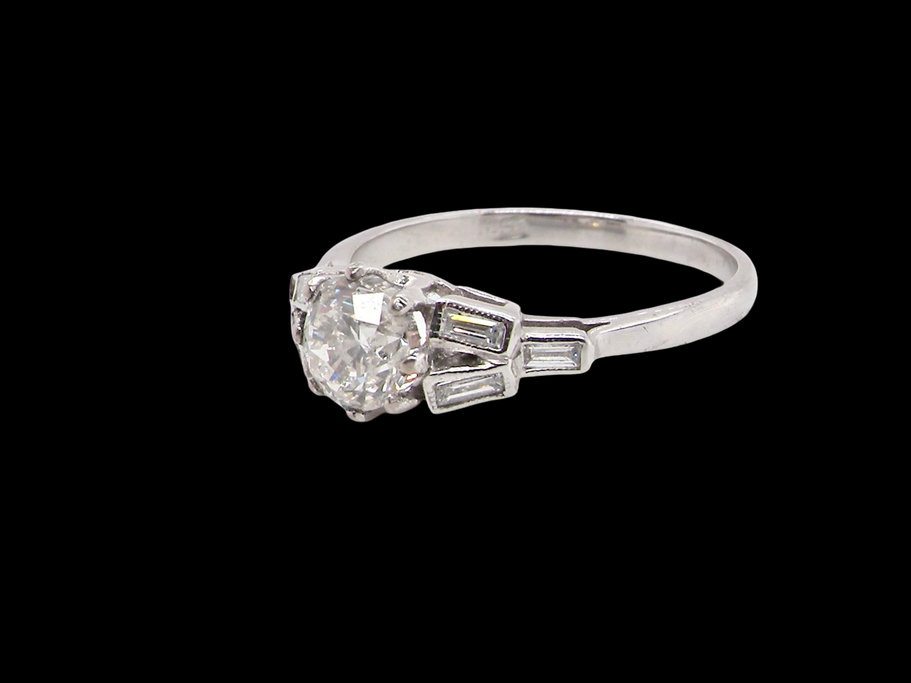 A beautifully proportioned Art Deco solitaire ring showcasing a sparkling old brilliant cut white diamond side