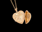 A charming heart-shaped locket, beautifully detailed with delicate scrolled engraving 