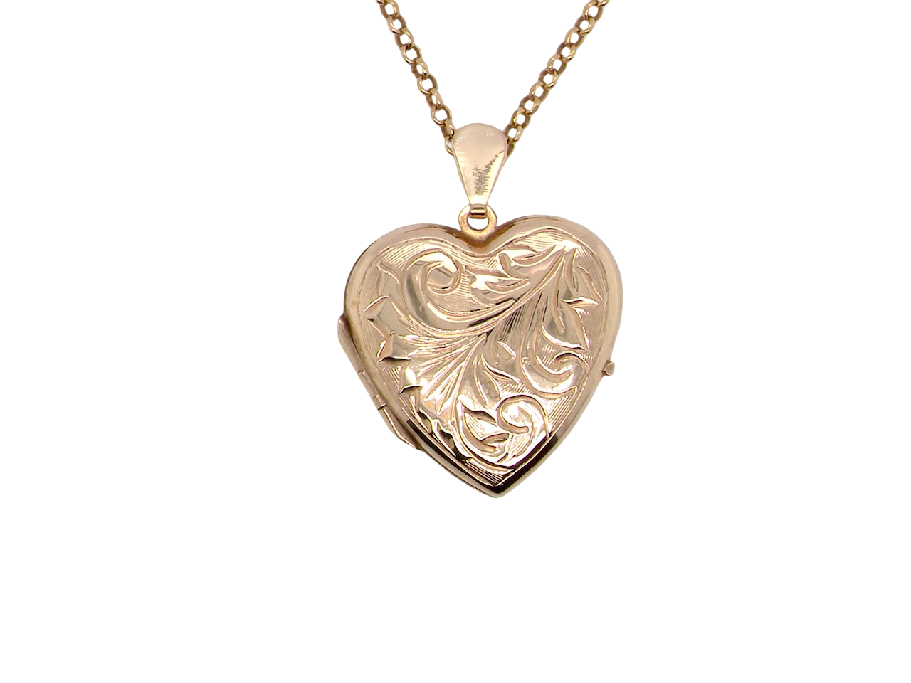 A charming heart-shaped locket,  detailed with delicate scrolled engraving to the front. 