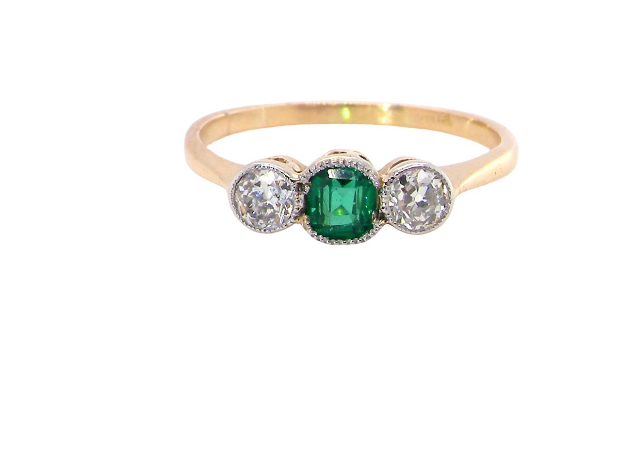 A charming ring dating from the early to mid-20th century, beautifully crafted and full of period character.

The centrepiece is a vivid bright-green, cushion-shaped emerald 