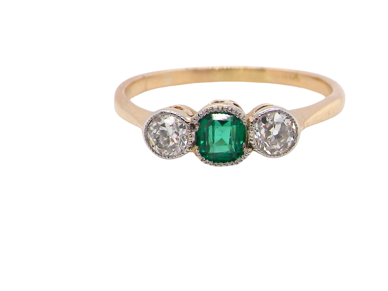 A charming ring dating from the early to mid-20th century, beautifully crafted and full of period character.

The centrepiece is a vivid bright-green,  emerald 