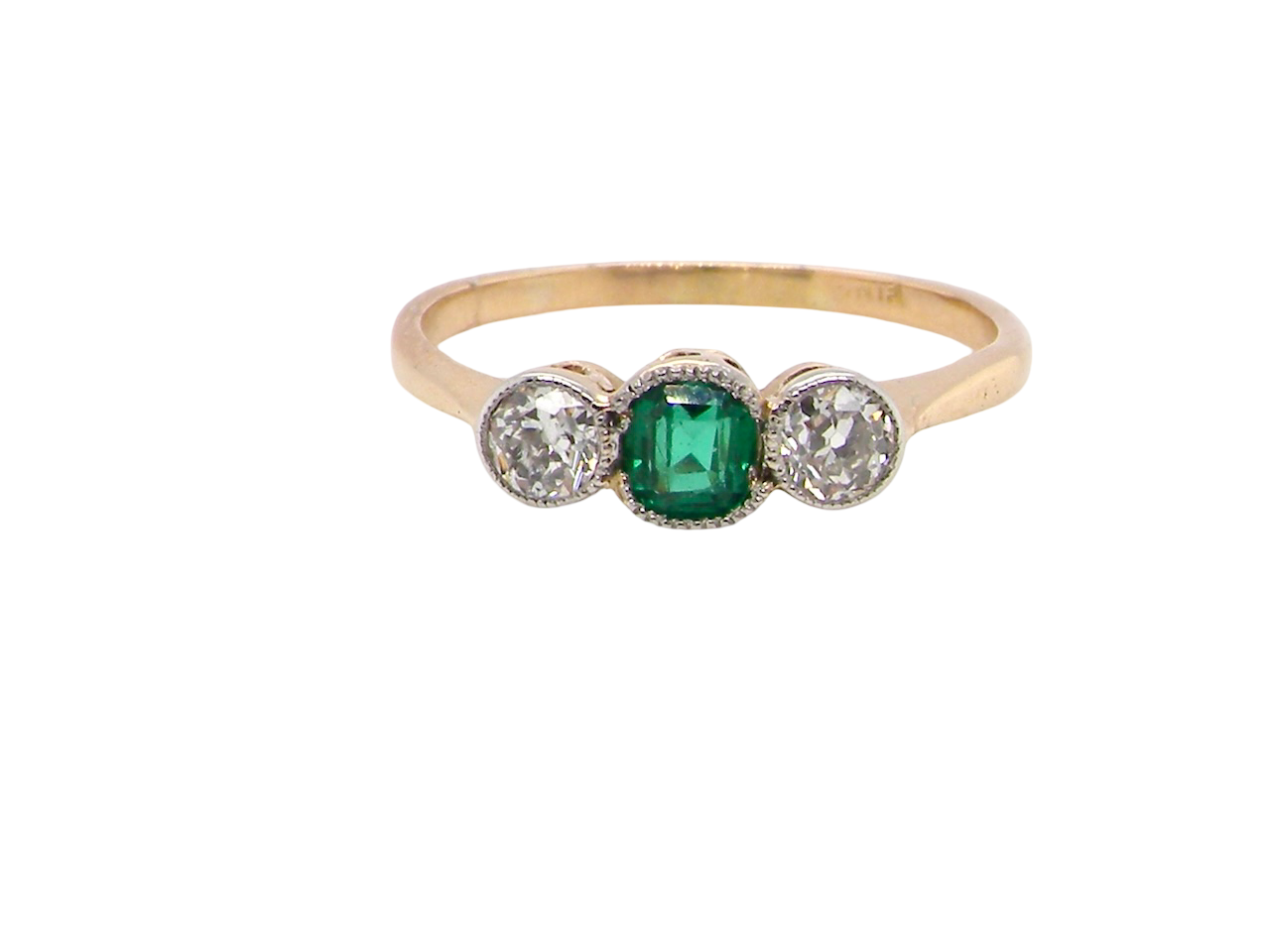 A charming ring dating from the early to mid-20th century, beautifully crafted and full of period character.

The centrepiece is a  bright-green, cushion-shaped emerald 