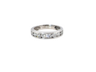 A silver-toned diamond eternity ring with a channel-set row of round-cut diamonds on a plain white background.