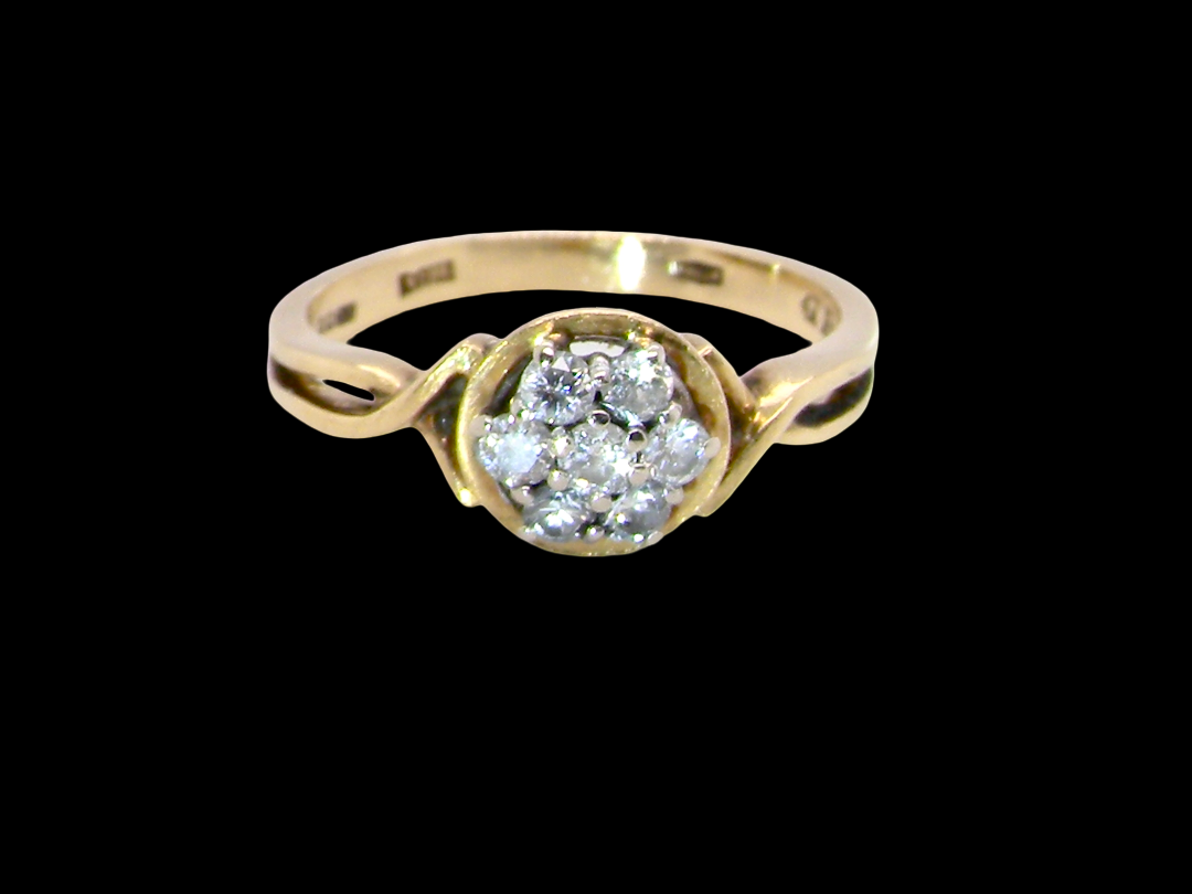 A classic 1980s cluster ring. Seven brilliant cut white diamonds , each 2.5mm (est 0.40 carats). Colour i-j, clarity Si. 