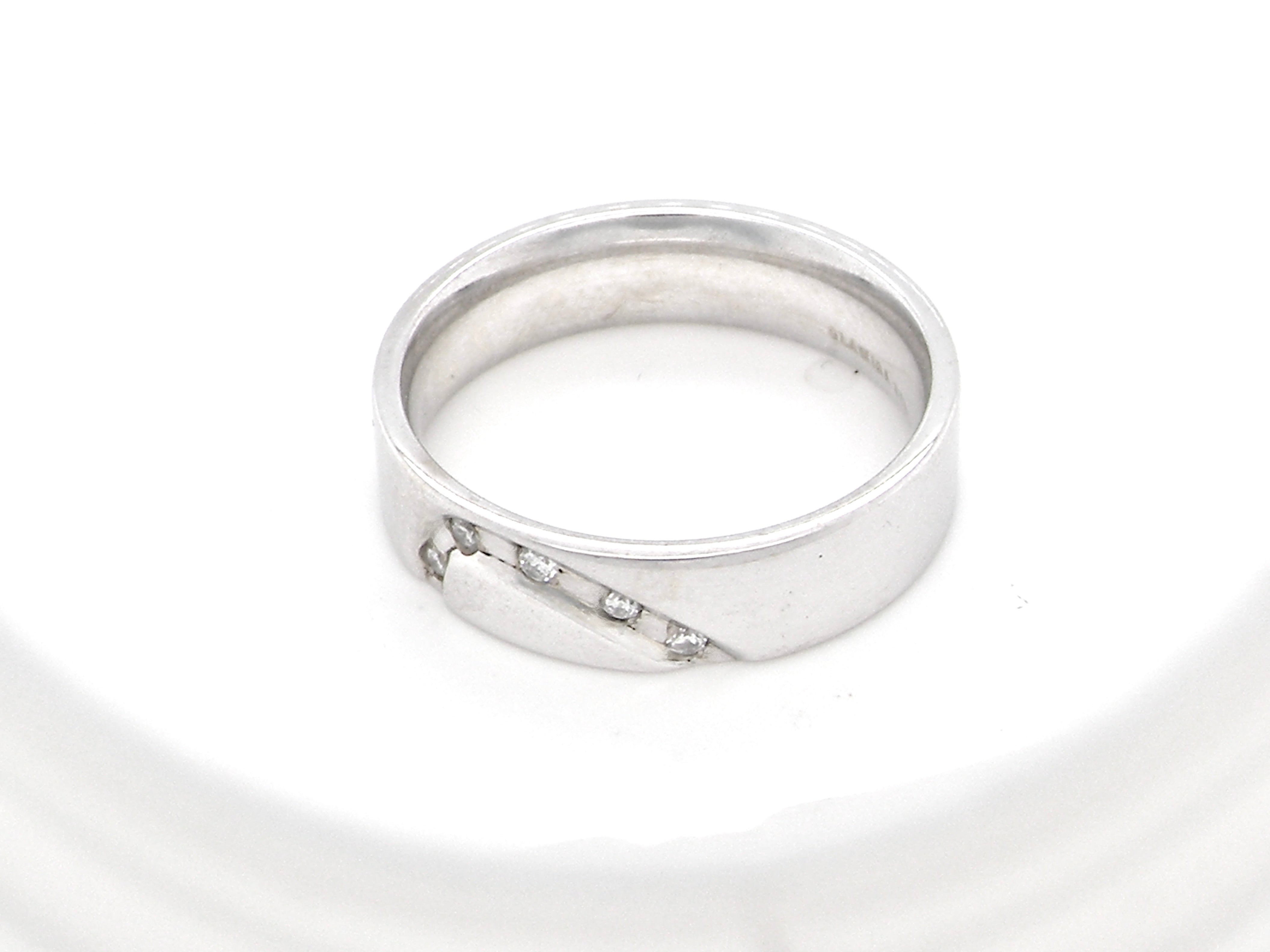 A classic 9 carat white gold ring with a timeless wedding-band style, equally suited to wear as a simple diamond dress ring. 