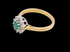 A classic cluster ring. Features to the centre a round emerald, comlimented by an outer halo of brilliant cutdiamonds