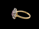 A  cluster ring featuring a beautiful cushion-cut pink sapphire side view