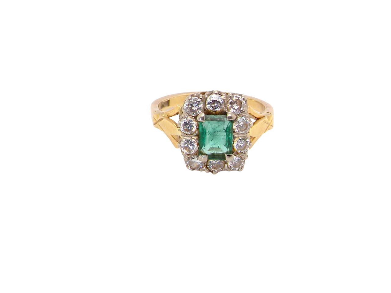 A cluster ring that features a rectangular emerald centre stone, 7x5mm . Deep green colour, natural inclusions that can be seen under an eye glass, but not easily visible via the naked eye.