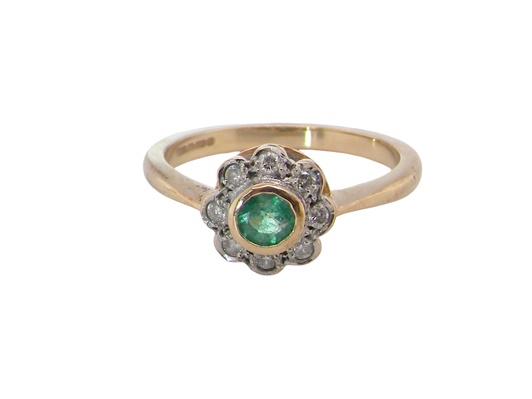 A vintage-style gold ring featuring a central round green emerald-cut gemstone surrounded by a halo of small clear stones, set on a plain white background.