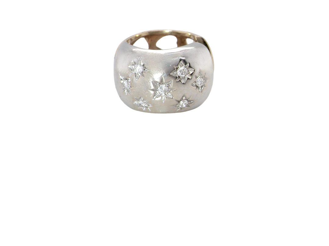 A  cuff style hoop earring. The front part is 18 carat white gold * set with seven small white diamonds, 