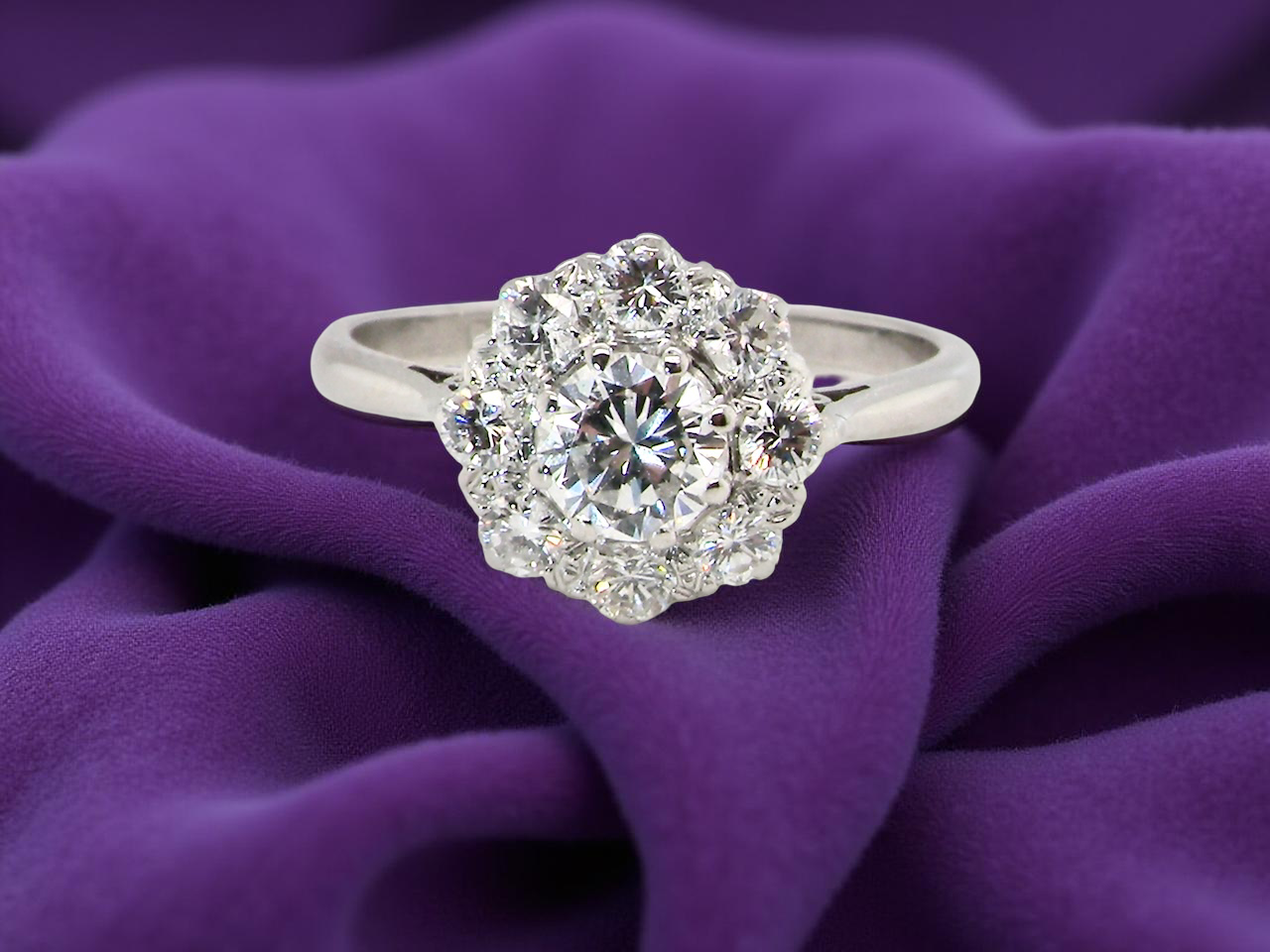 Diamond ring on a purple fabric background