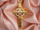 A fancy two colour gold cross and chain