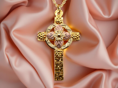 A fancy two colour gold cross and chain