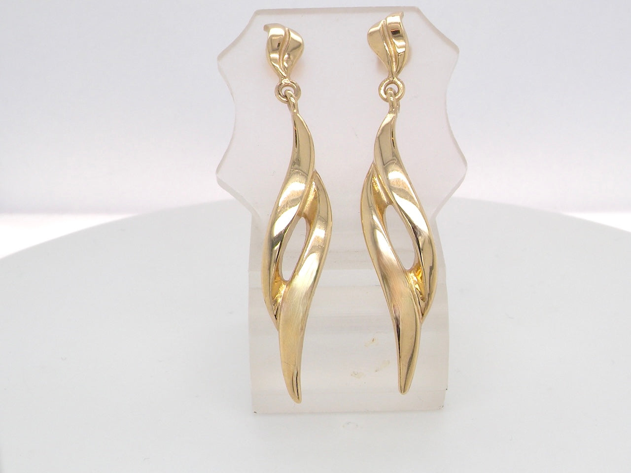 A feature pair of long drop earrings. Each a double loop that has a length of 38mm, width 8mm. Flame shaped top to the post and scroll.
