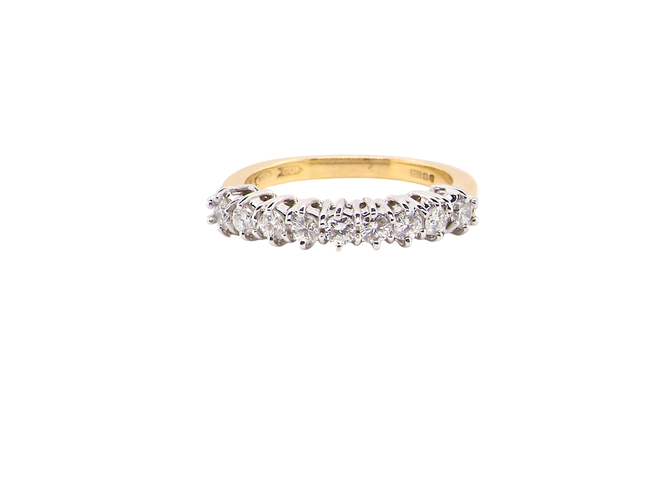 A fine 18 carat gold half hoop eternity ring, beautifully set with an array of seven brilliant-cut white diamonds.