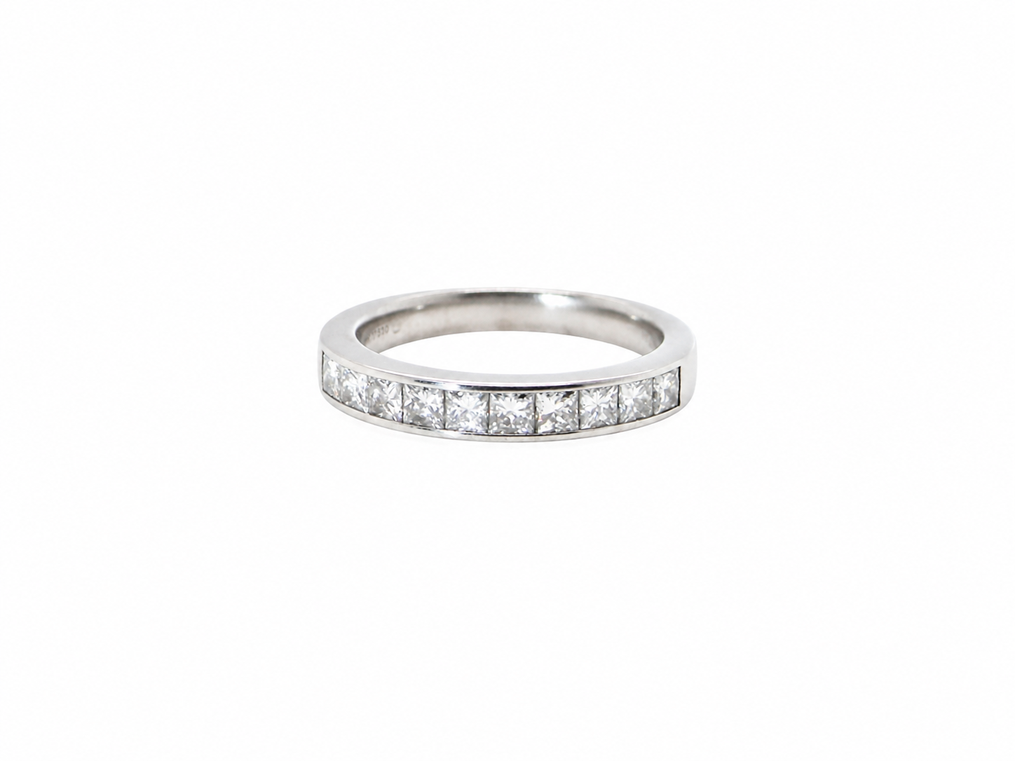A fine 18 carat white gold half hoop eternity ring. Set with ten princess cut white diamonds.

Close set, each 2.5x2.5mm, total one carat
