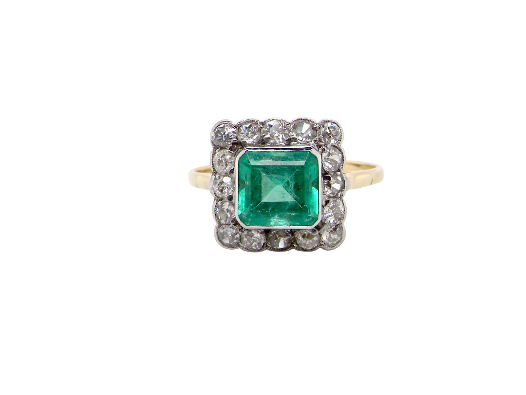A fine Art Deco emerald and diamond cluster ring, beautifully proportioned and displaying all the elegance associated with the period.