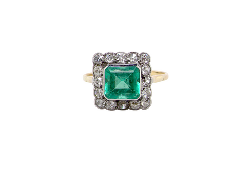 A fine Art Deco emerald and diamond cluster ring, beautifully proportioned and displaying all the elegance associated with the period.