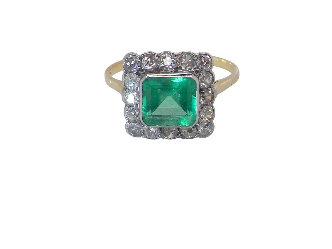 A fine Art Deco emerald and diamond cluster ring,  proportioned and displaying all the elegance associated with the period.