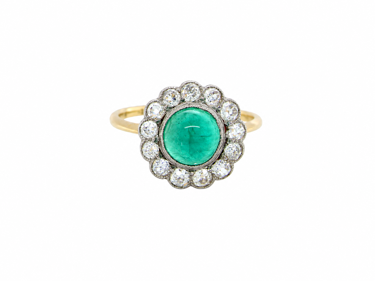 A fine antique cluster ring. The centre stone a cabouchon cut emerald