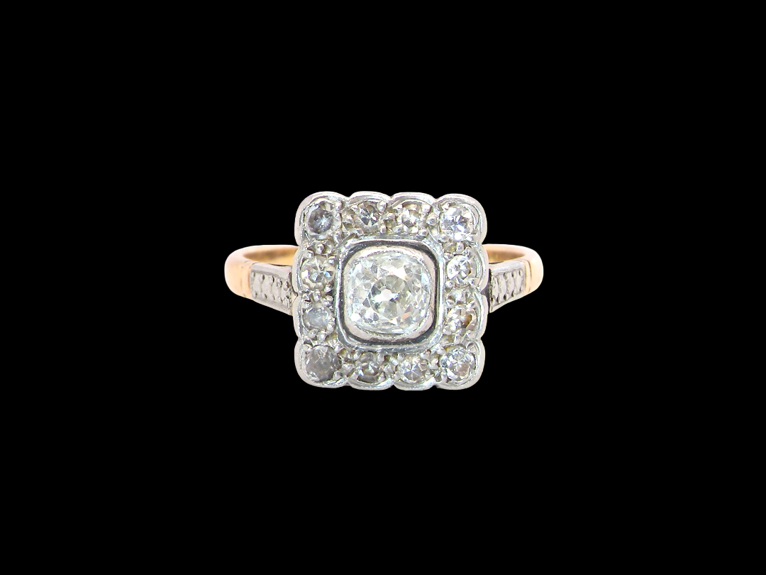 A fine antique ring from the early part of the 20th century (probably 1915-1925)

A square head that measures 11x11mm is set with old brilliant cut white diamonds. The principal stone measures just over half a carat  colour i-l, clarity Si, rim setting, platinum.
