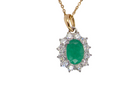 A fine cluster pendant. Features at the centre an oval cut emerald, measures 7.5x5mm (est one carat). natural inclusions.
