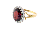 side view A fine cluster ring. Features a large garnet centre stone&nbsp;

Complimented by an outer halo of brilliant cut white diamonds.&nbsp;