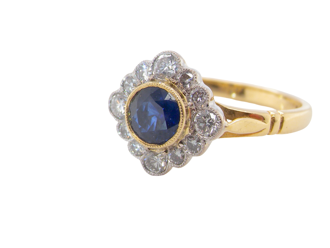 A fine cluster ring featuring to the centre a round dark blue sapphire, 5mm diameter (0.50 carats) mille grain setting.
side