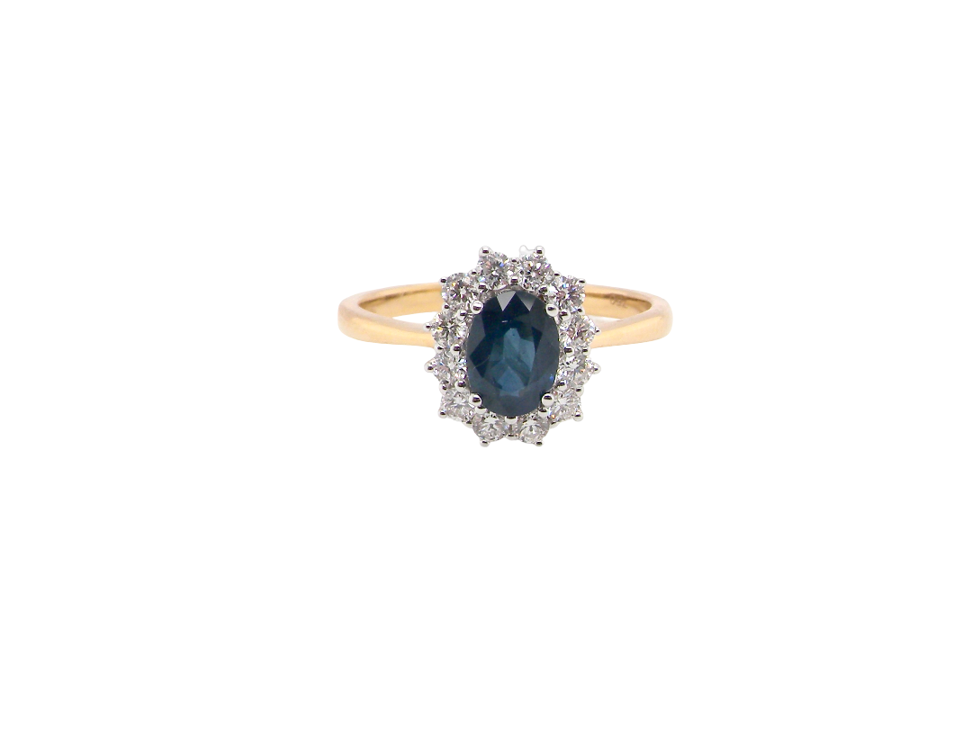 A fine cluster ring that features a black blue oval cut sapphire that measures 7x5mm (est 0.75 carats)
