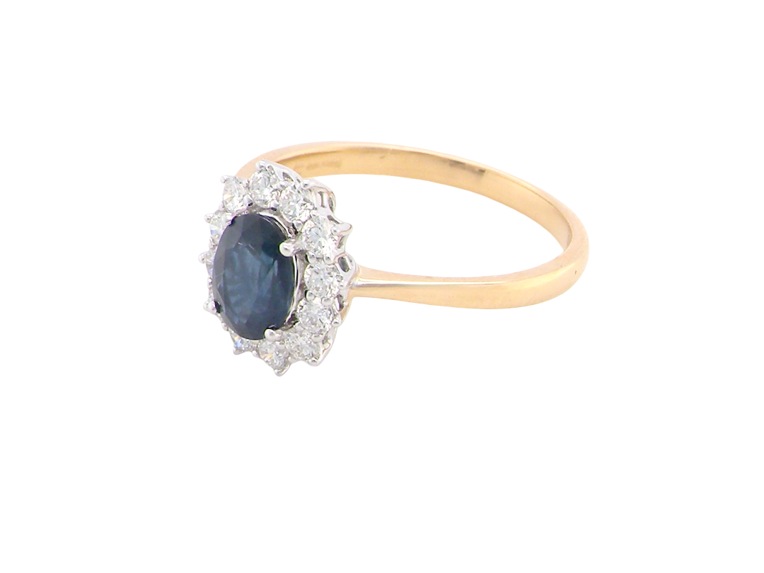 A fine cluster ring that features a black blue oval cut sapphire that measures 7x5mm (est 0.75 carats)
side