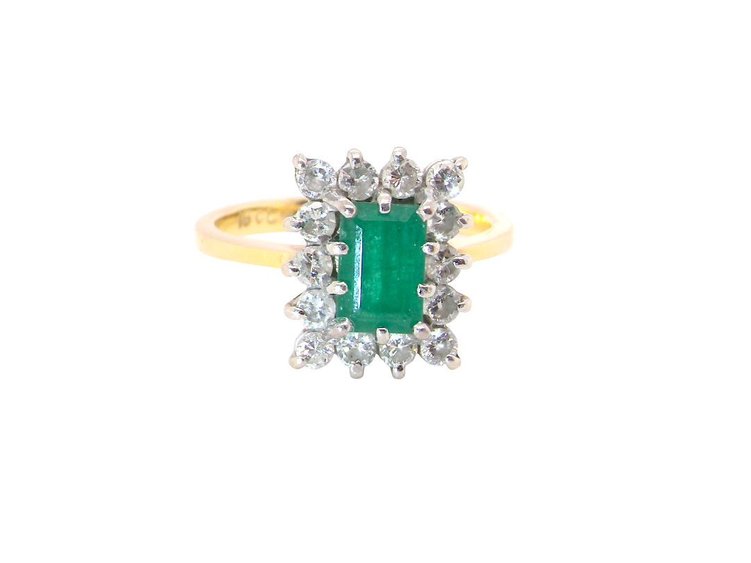 A yellow gold ring featuring a rectangular emerald-cut green gemstone surrounded by a halo of small clear round-cut stones, set against a plain white background.