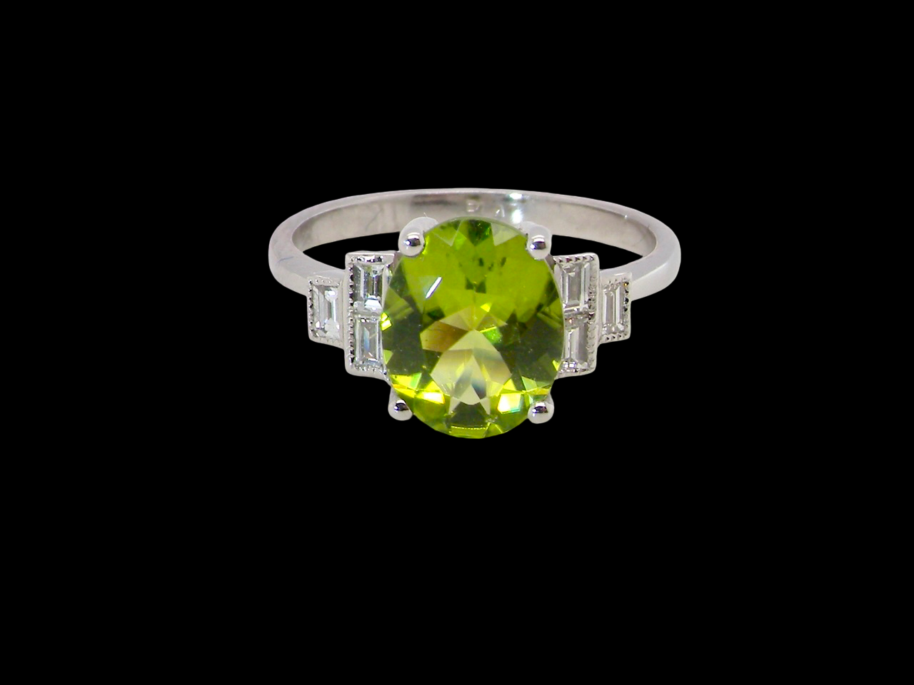 A fine gem set ring featuring an  oval faceted peridot,