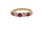 A fine half hoop ring. 18 carat gold set with three rubies, each 3.8mm (est 0.20 carats, total 0.67 carats) and four brilliant cut white diamonds, each 3.8mm 
