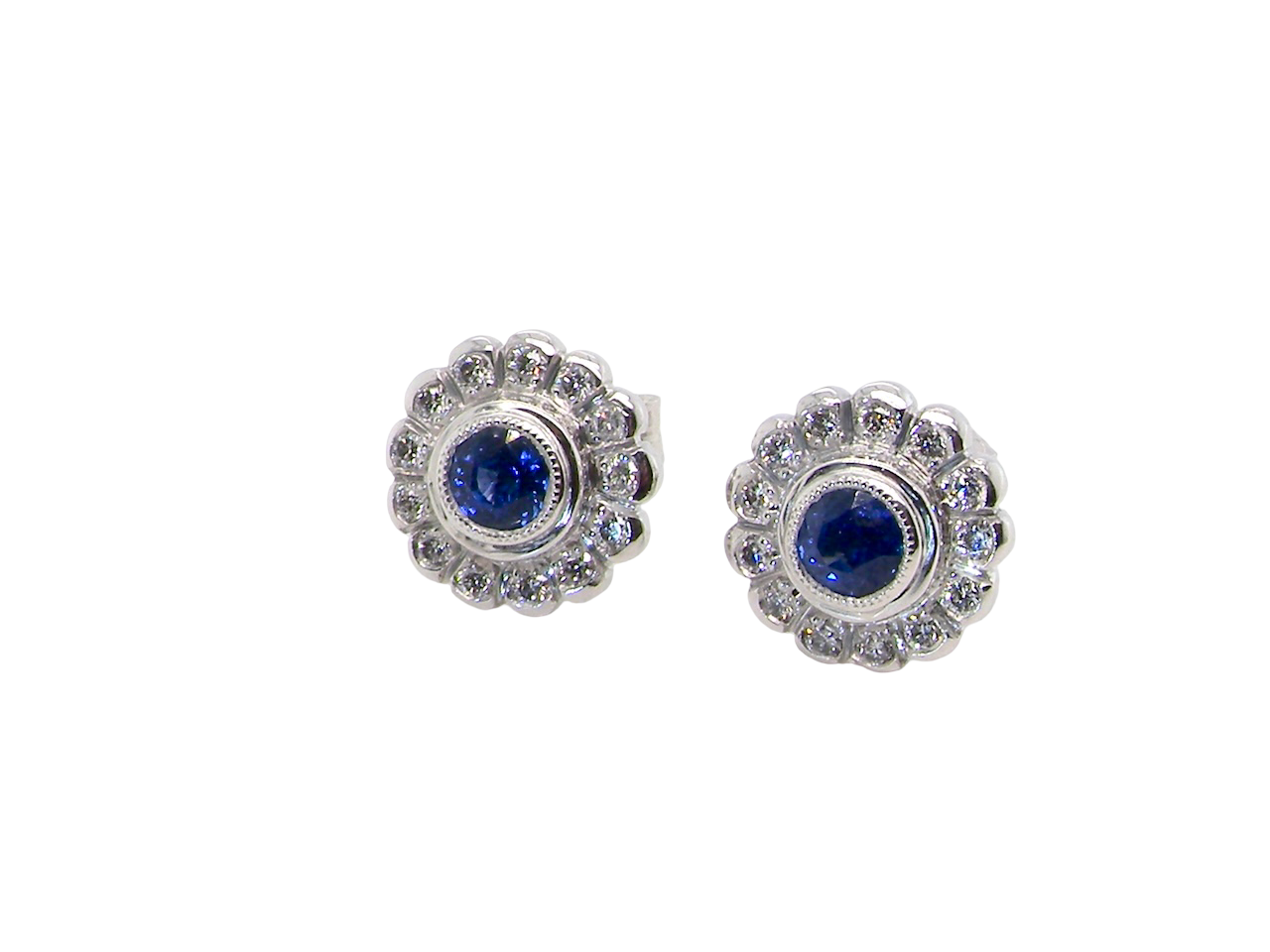  A fine pair of 18 carat white gold sapphire and diamond cluster earrings.

Each earring is set with a central round sapphire measuring approximately 3.4mm in diameter, estimated at 0.15ct, 
